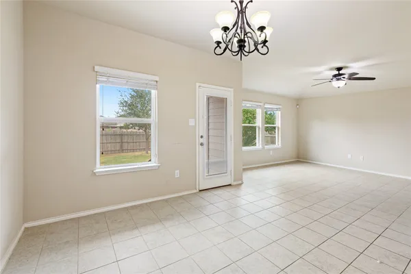 a view of a kitchen with a sink and a chandelier fan
