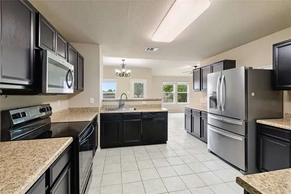 a kitchen with a refrigerator and a sink