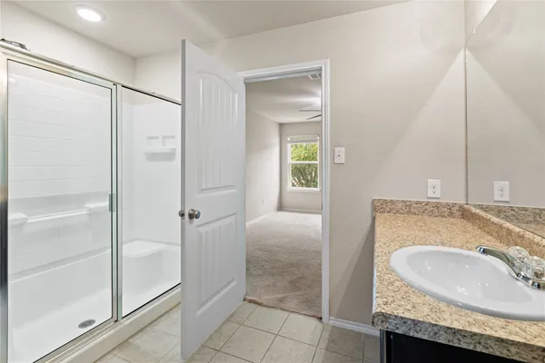 a bathroom with a granite countertop sink a toilet and a mirror