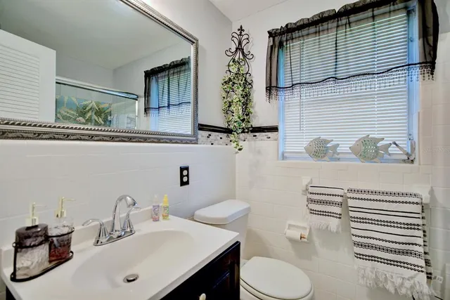 a bathroom with a toilet sink and shower