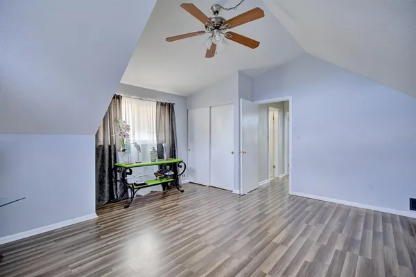a view of empty room with wooden floor