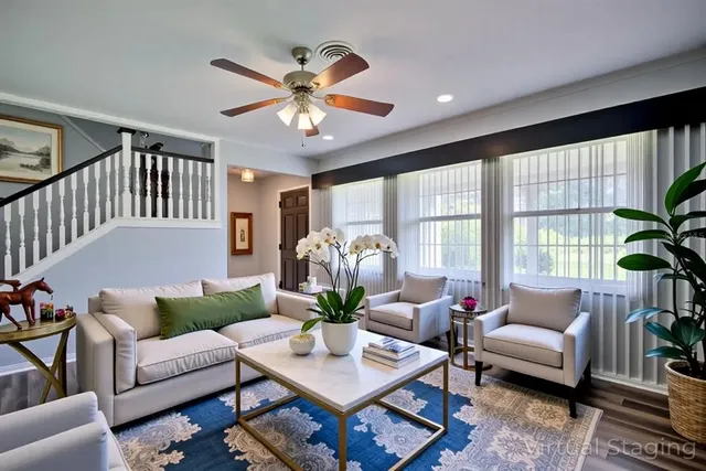 a living room with furniture chandelier and a large window