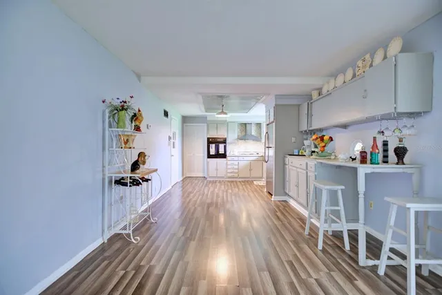 a view of a living room with furniture and wooden floor
