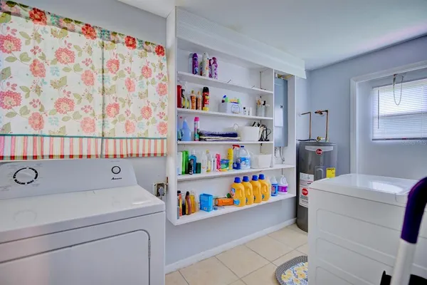 a bedroom with a bed a couch and a dresser