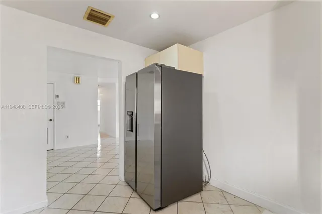 an empty room with wooden floor ceiling fan and window