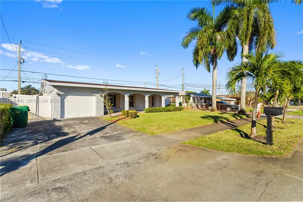 a view of house with outdoor space and palm tree