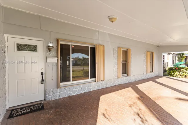 a view of a bedroom with wooden floor and windows