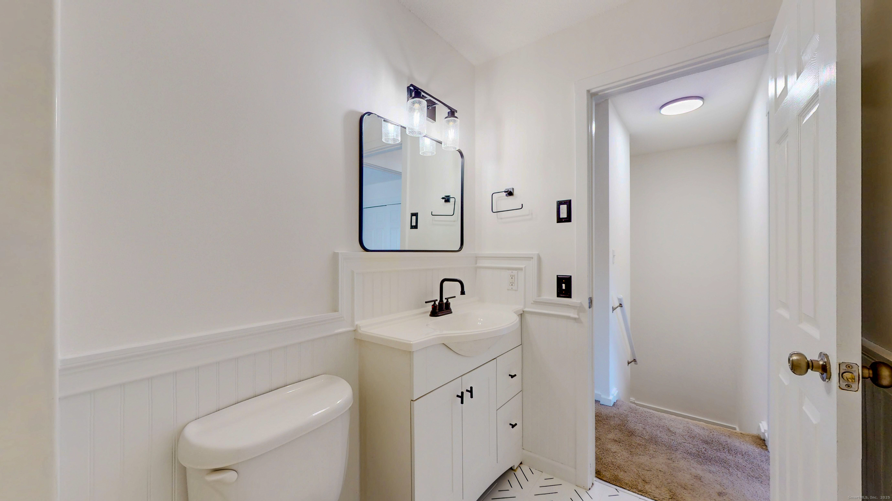 4 Fox Run, Unit 4 Woodbury, CT 06798 - Photo 12 of 25 a bathroom with a toilet sink and mirror