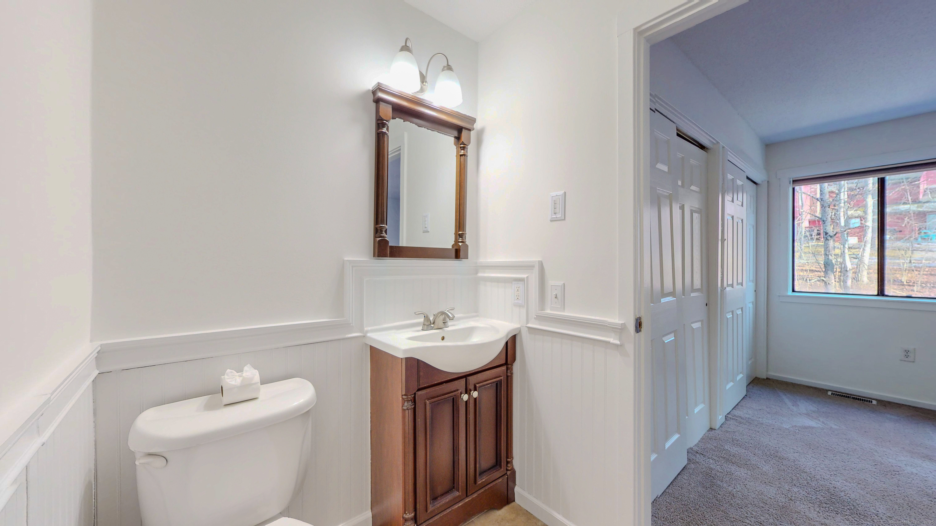 4 Fox Run, Unit 4 Woodbury, CT 06798 - Photo 17 of 25 a bathroom with a toilet sink and mirror