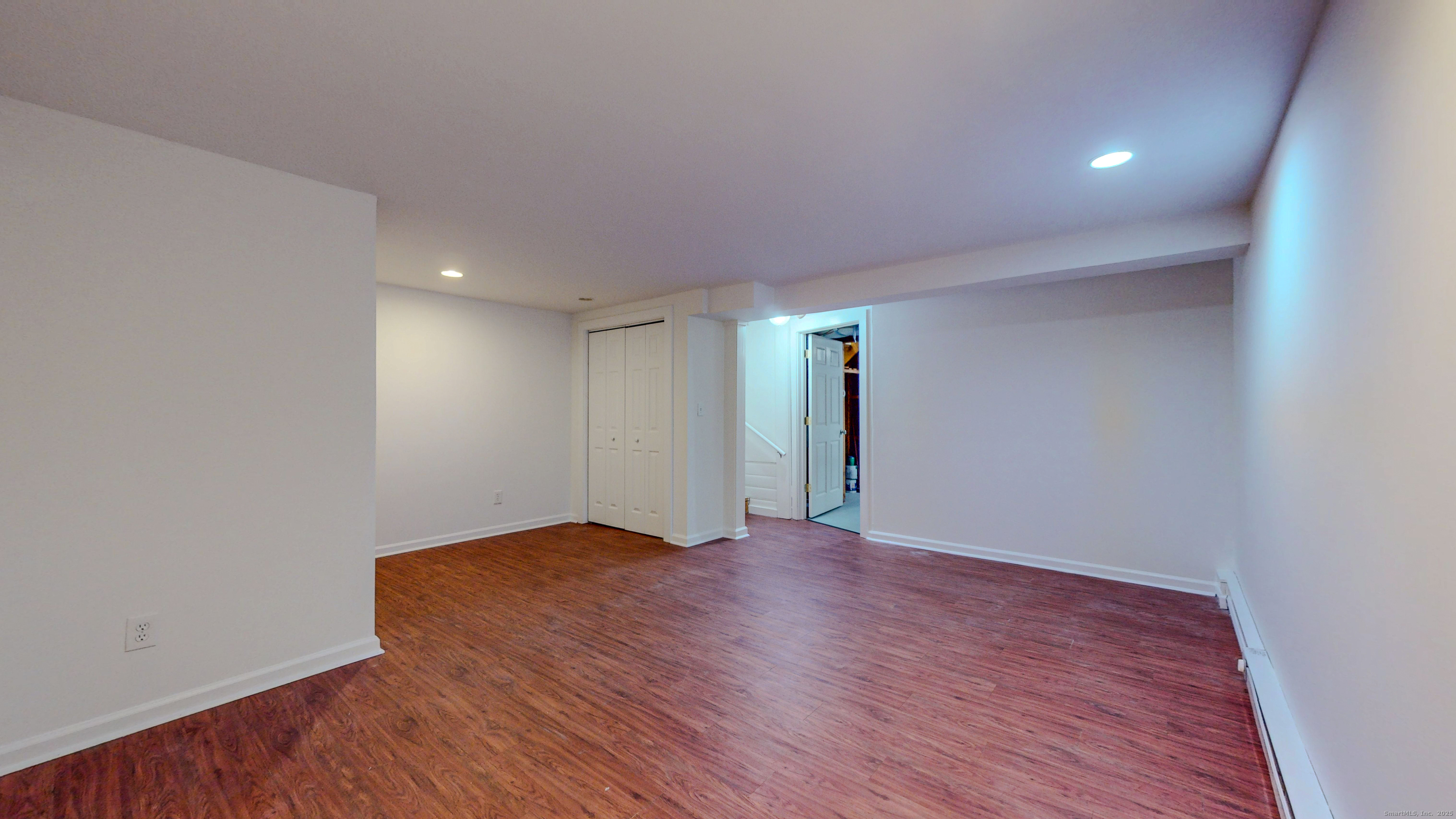 4 Fox Run, Unit 4 Woodbury, CT 06798 - Photo 18 of 25 a view of an empty room with wooden floor