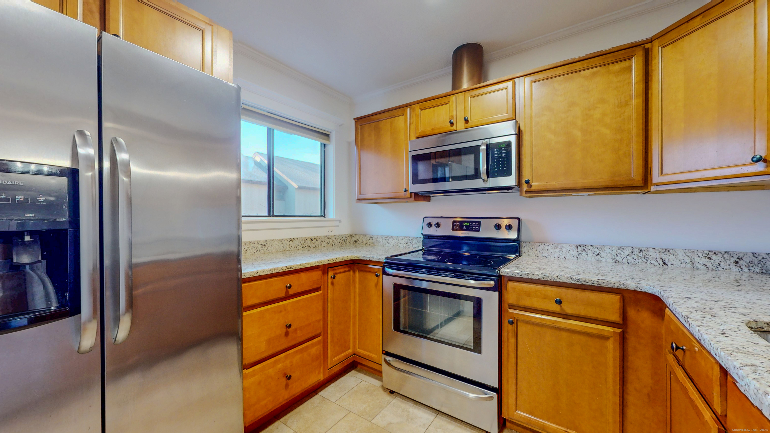 4 Fox Run, Unit 4 Woodbury, CT 06798 - Photo 4 of 25 a kitchen with stainless steel appliances granite countertop a stove a sink and a microwave