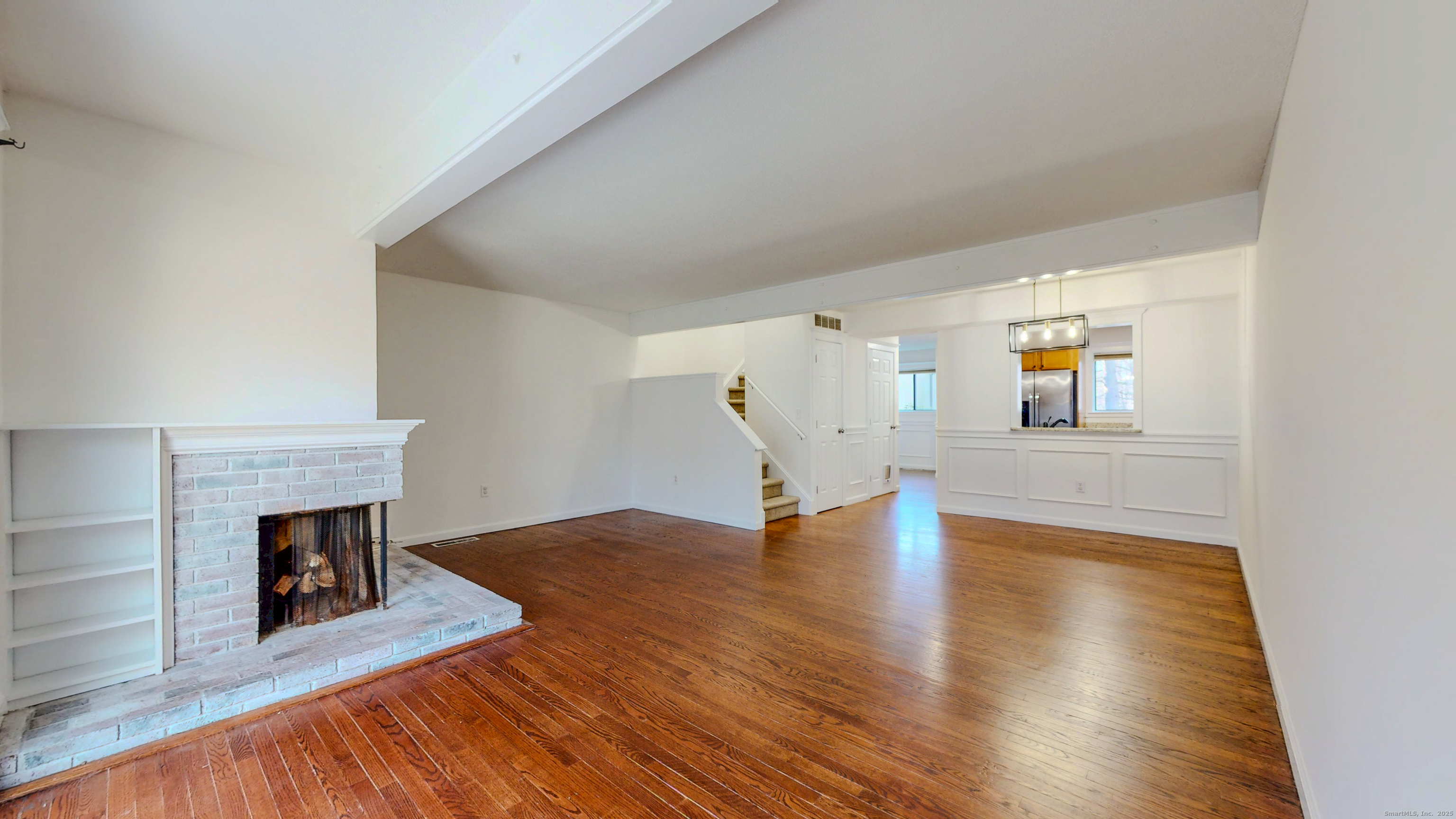 4 Fox Run, Unit 4 Woodbury, CT 06798 - Photo 9 of 25 a view of empty room with wooden floor and fireplace