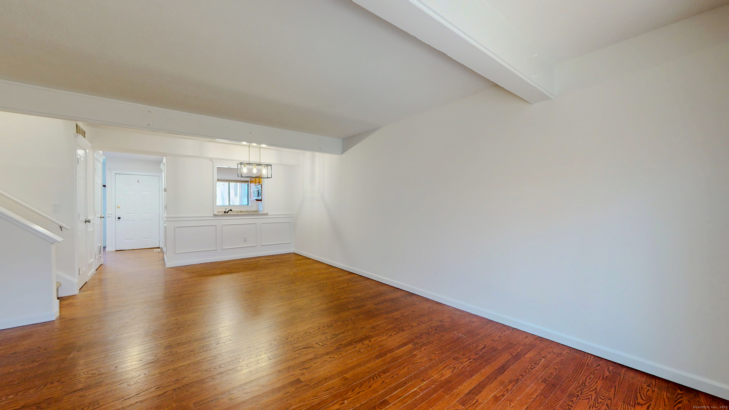 4 Fox Run, Unit 4 Woodbury, CT 06798 - Photo 10 of 25 a view of an empty room with wooden floor and a window