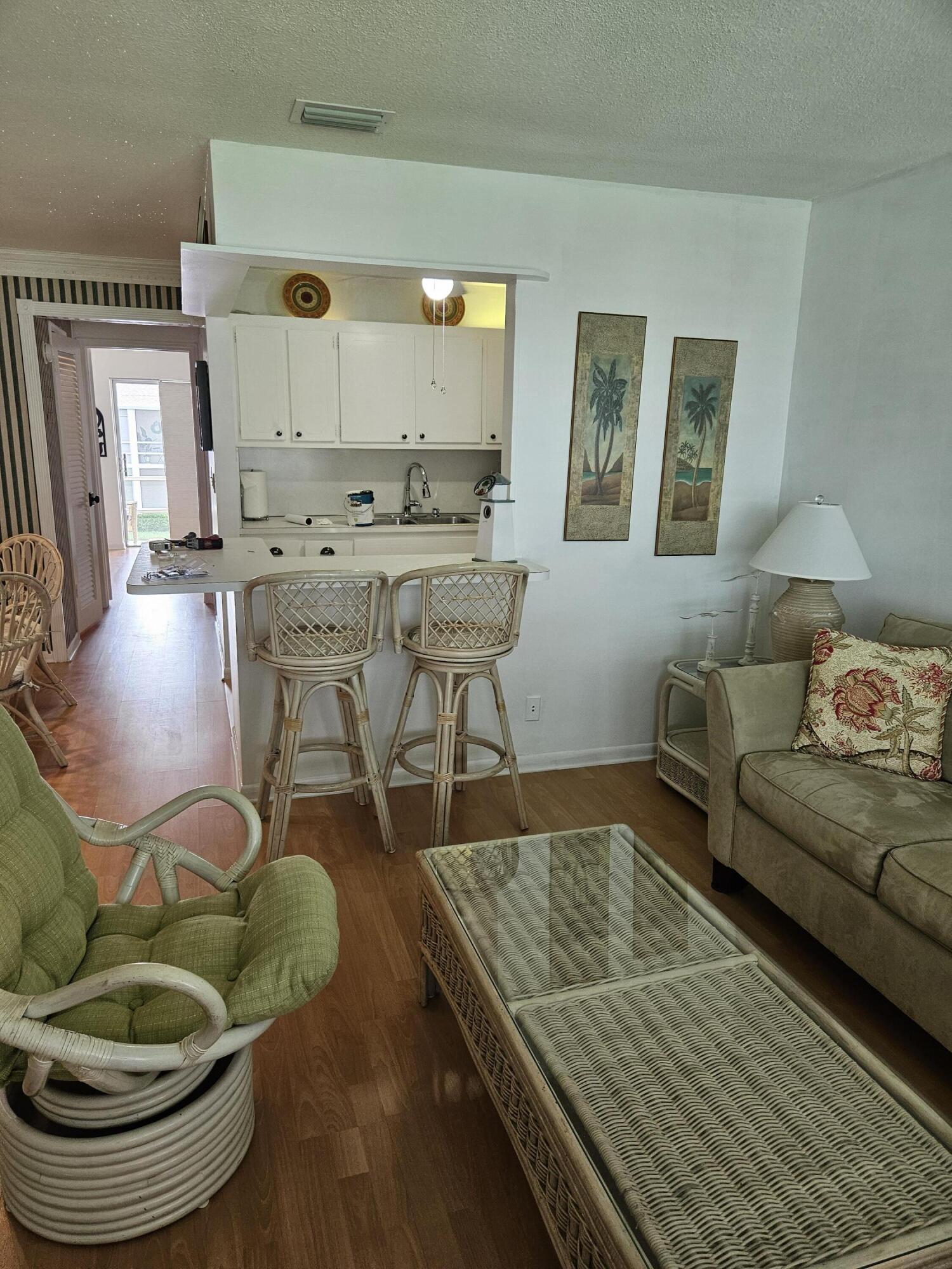 680 Horizon West, Unit 211 Boynton Beach, FL 33435 - Photo 1 of 6 a living room with furniture and a wooden floor