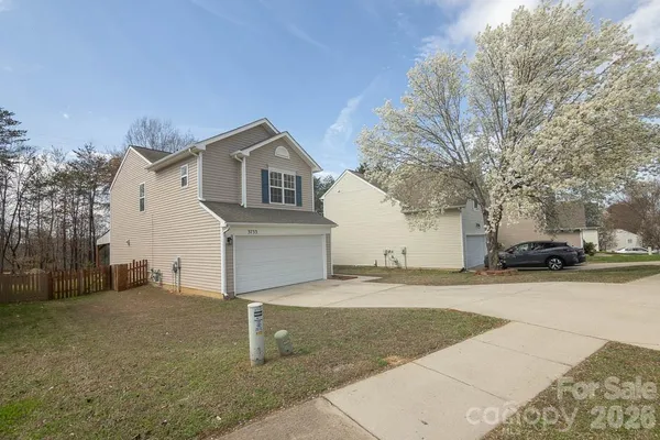 a house that has a tree in front of it