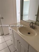 4824 Southwest 152nd Court, Unit 32G Miami, FL 33185 - Photo 15 of 24 a bathroom with a sink and a mirror