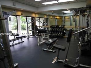 4824 Southwest 152nd Court, Unit 32G Miami, FL 33185 - Photo 21 of 24 a view of a room with gym equipment