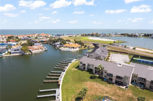 an aerial view of a swimming pool patio and lake view
