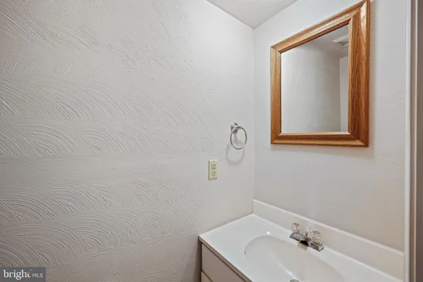 a bathroom with a sink and mirror