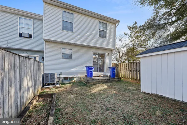 a view of a house with a yard and wooden fence