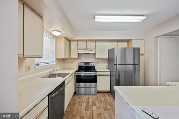a kitchen with a sink a stove and refrigerator
