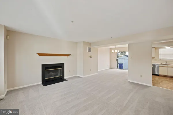 a view of empty room with a fireplace
