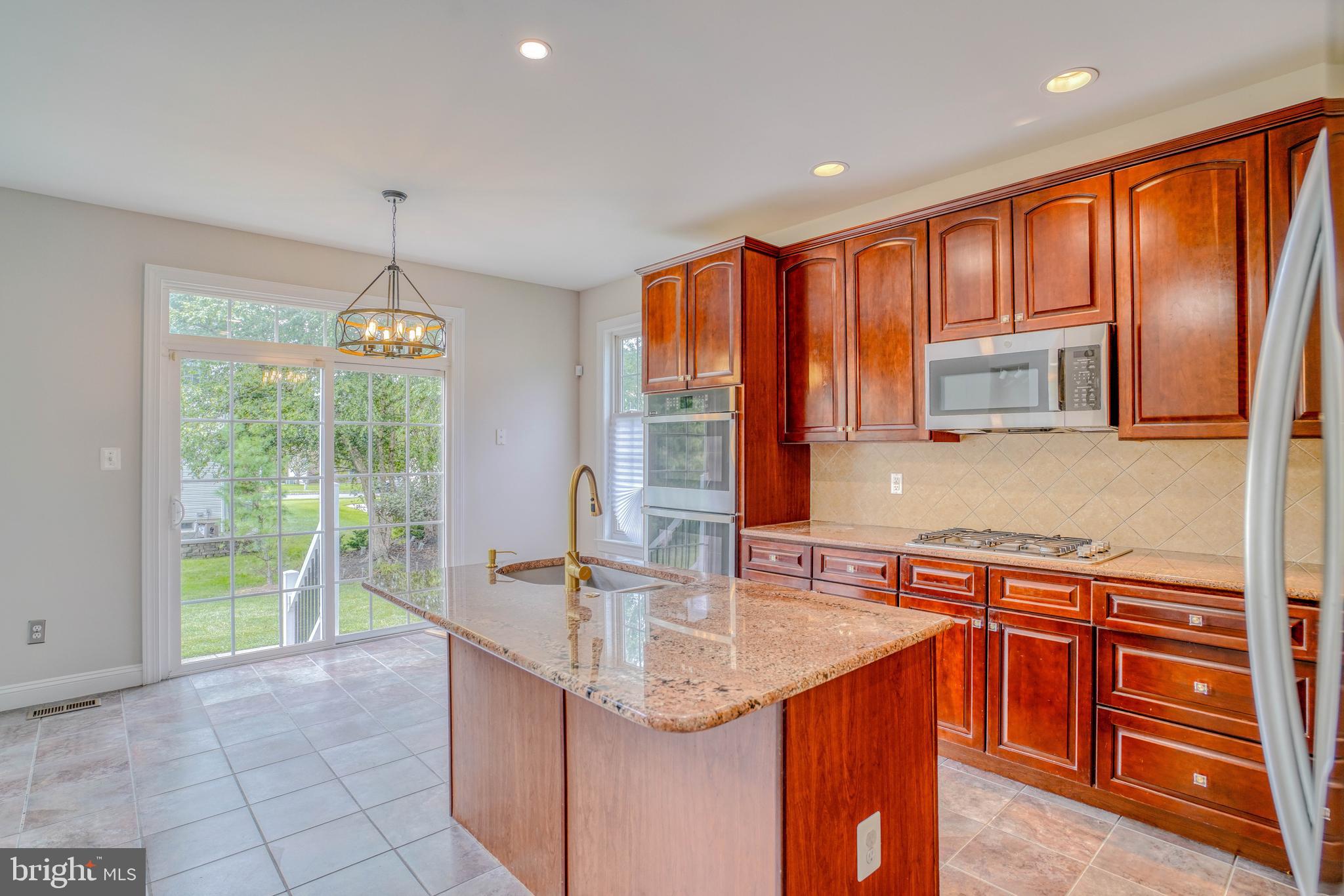 9902 Player Drive Philadelphia, PA 19115 - Photo 20 of 67 a kitchen with stainless steel appliances granite countertop sink stove and refrigerator