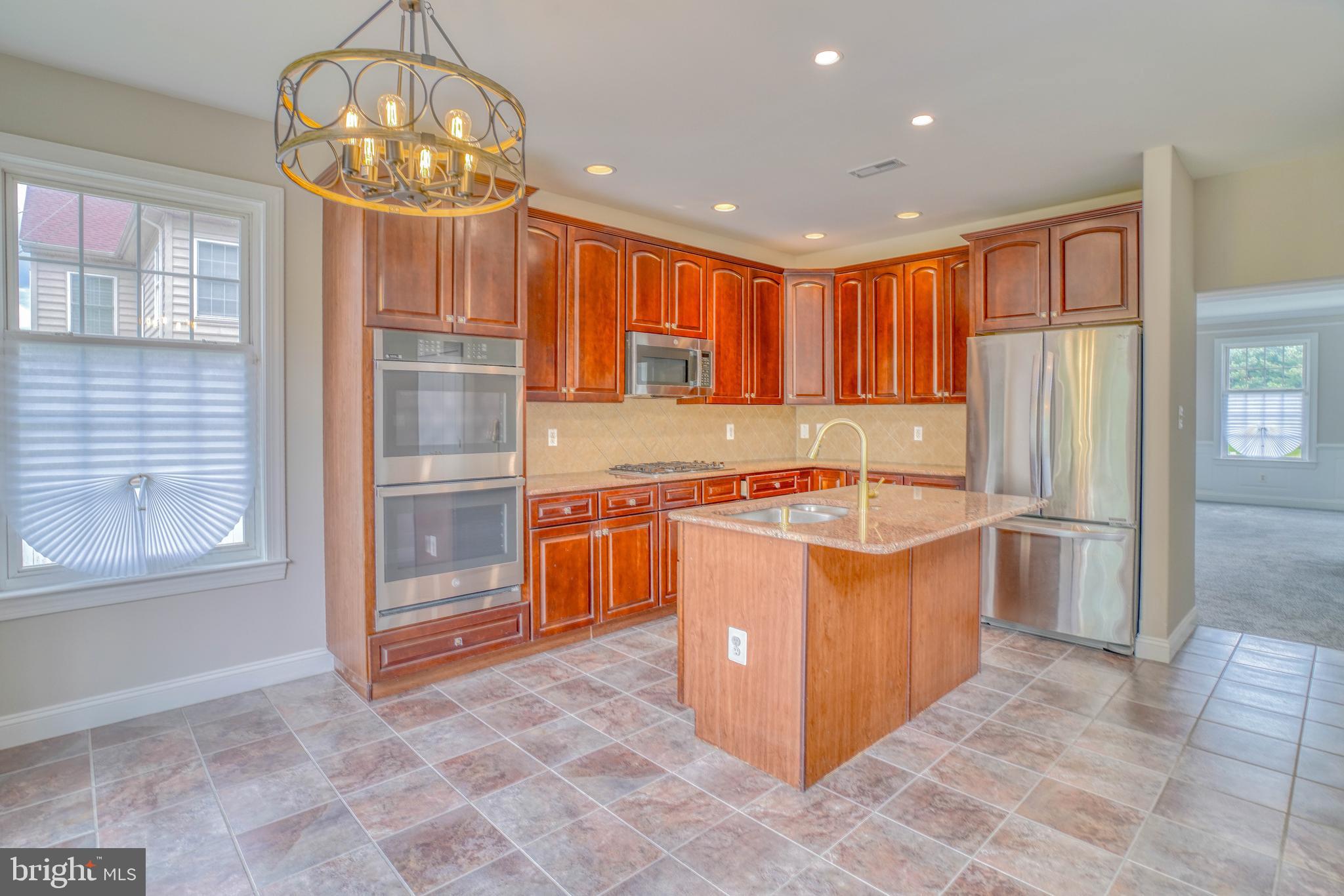 9902 Player Drive Philadelphia, PA 19115 - Photo 26 of 67 a kitchen with stainless steel appliances granite countertop a stove top oven a sink dishwasher and a refrigerator