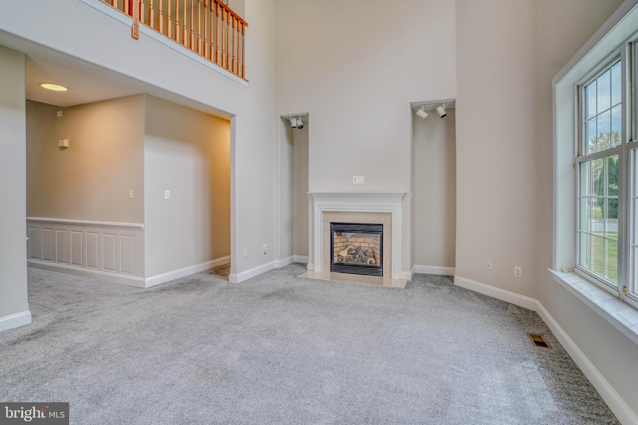 9902 Player Drive Philadelphia, PA 19115 - Photo 27 of 67 an empty room with windows and fireplace