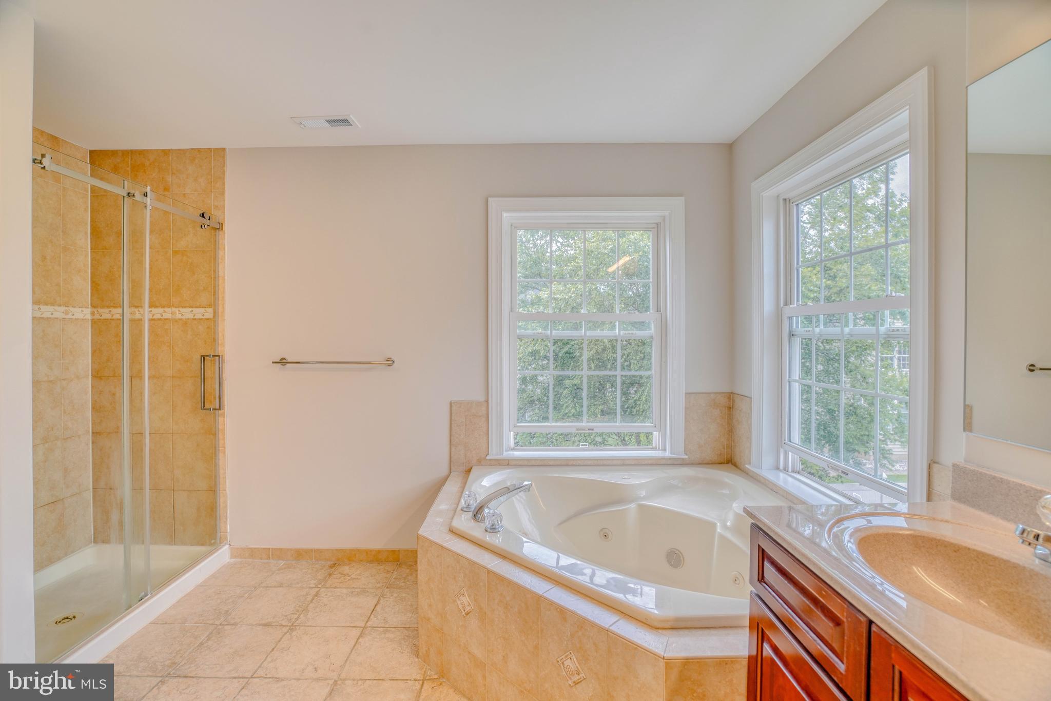 9902 Player Drive Philadelphia, PA 19115 - Photo 43 of 67 a white bath tub sitting in a bathroom next to a window