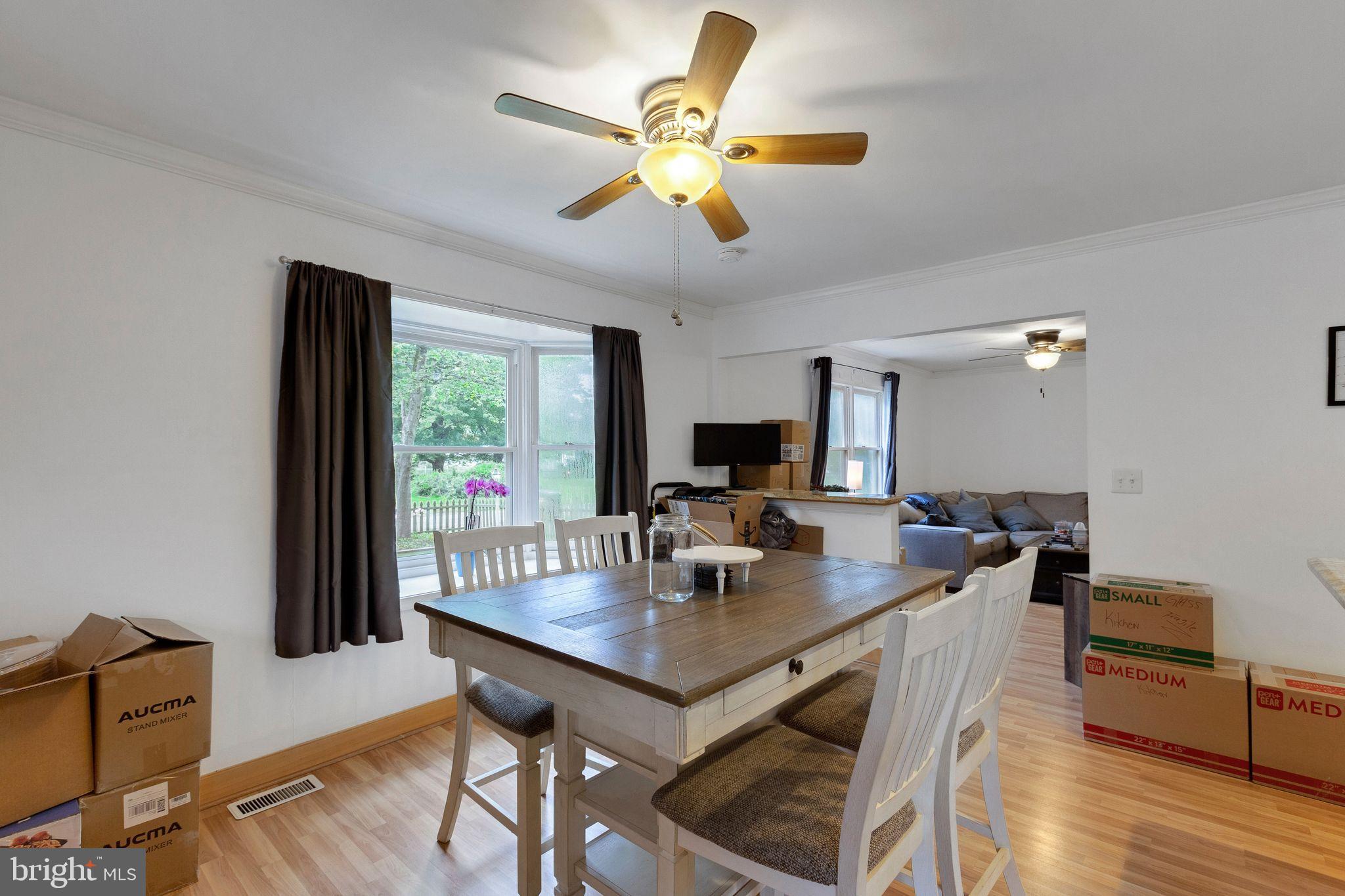 128 7th Street Colonial Beach, VA 22443 - Photo 13 of 32 a view of a dining room with furniture window and wooden floor