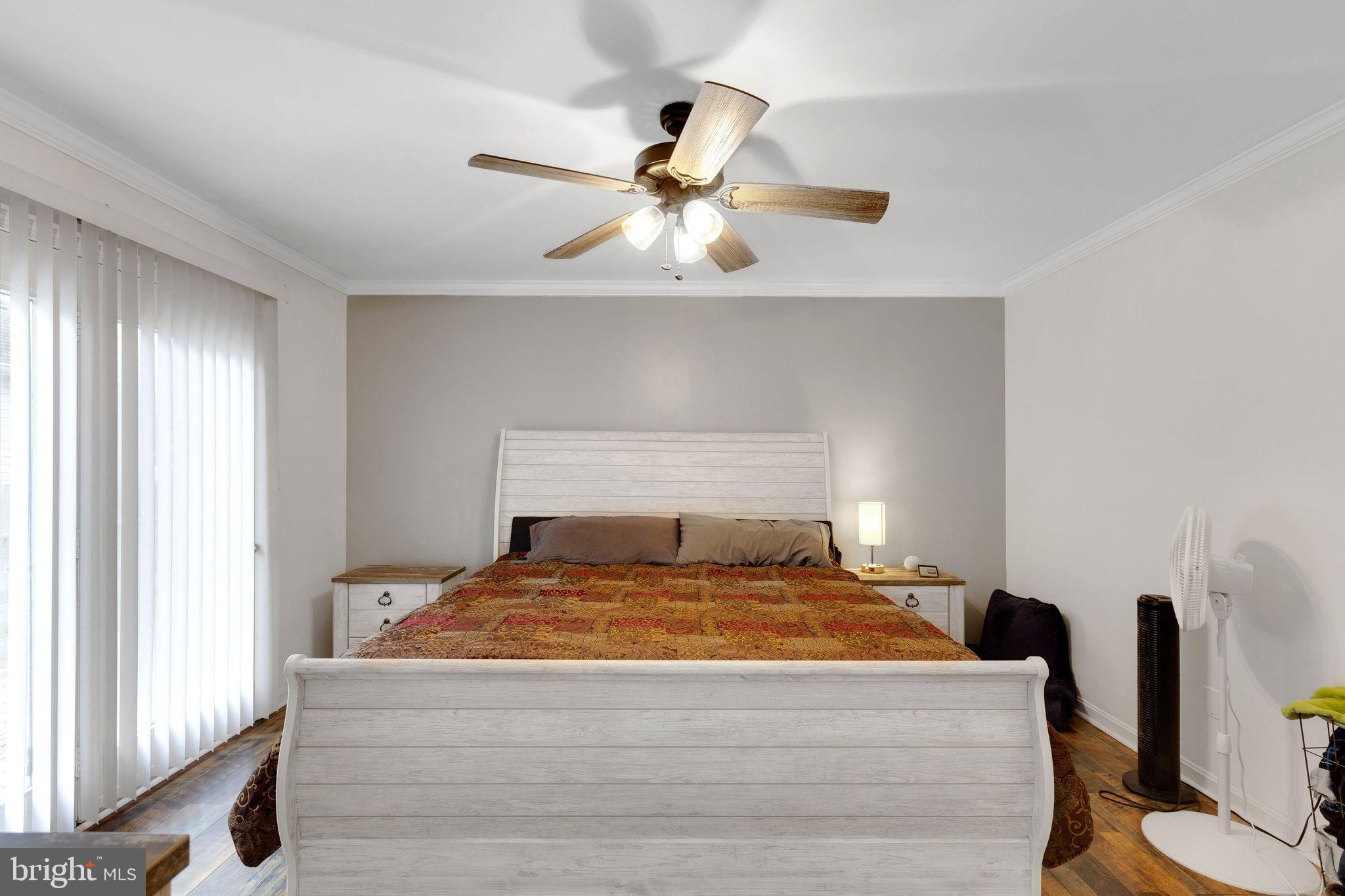 128 7th Street Colonial Beach, VA 22443 - Photo 14 of 32 a bedroom with a bed and window