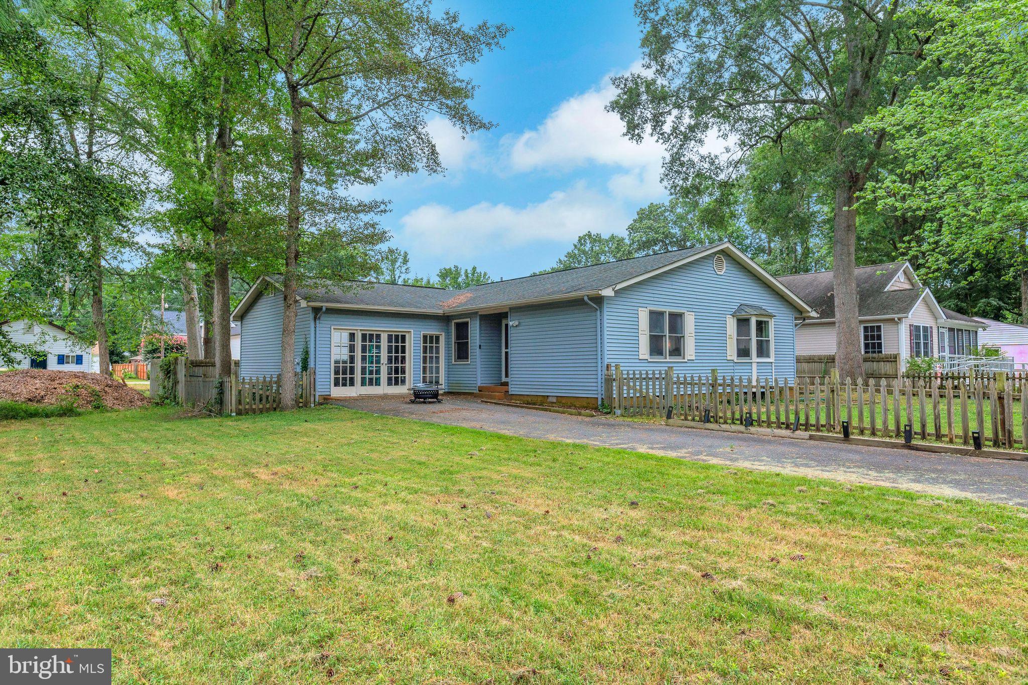 128 7th Street Colonial Beach, VA 22443 - Photo 25 of 32 a view of a house with a yard and deck