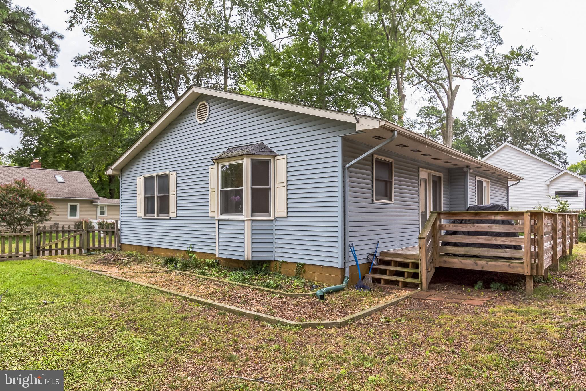 128 7th Street Colonial Beach, VA 22443 - Photo 27 of 32 a view of a house with a yard and wooden fence