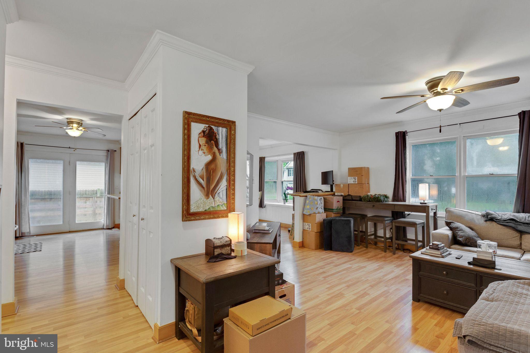 128 7th Street Colonial Beach, VA 22443 - Photo 4 of 32 a living room with furniture two window and wooden floor