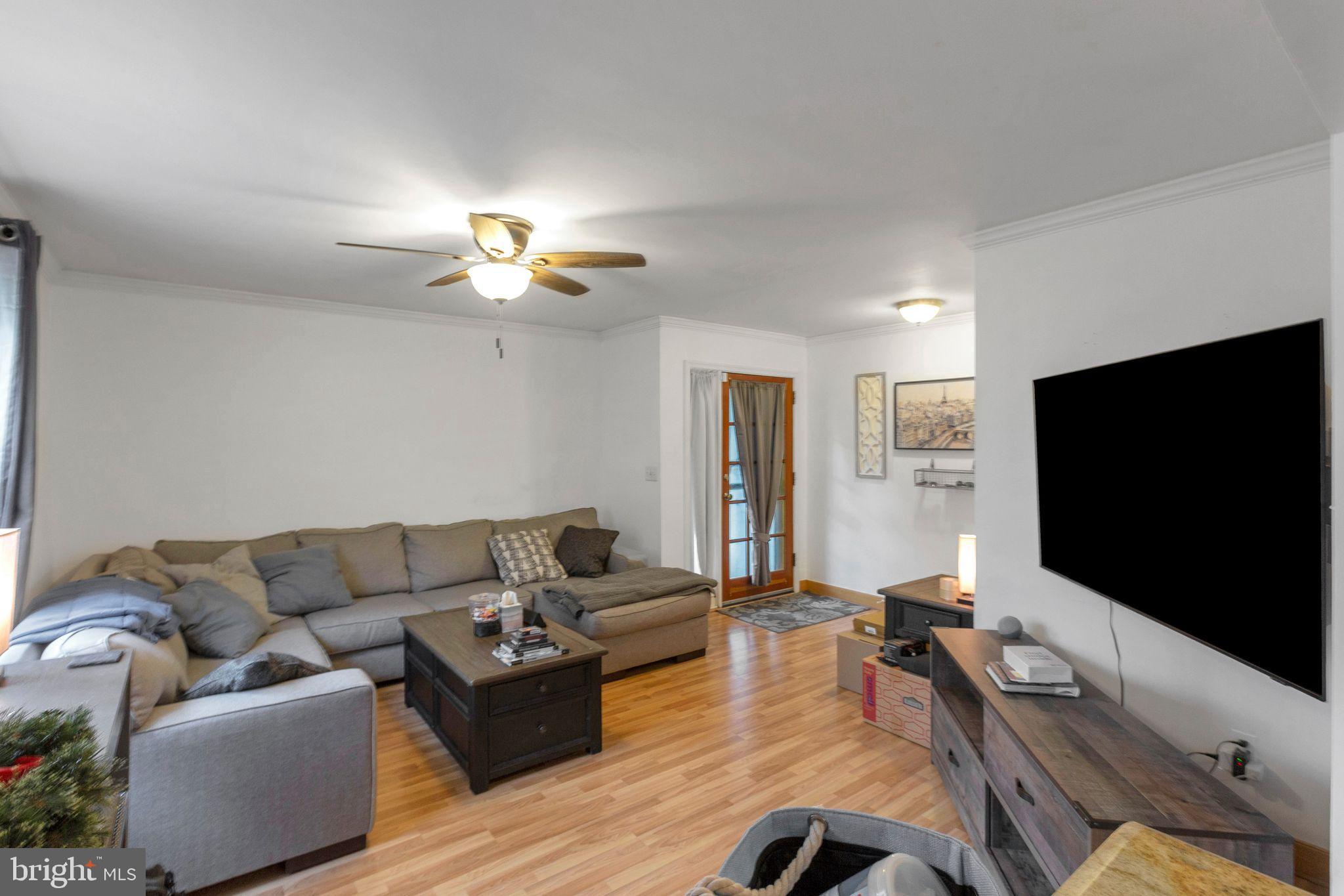 128 7th Street Colonial Beach, VA 22443 - Photo 5 of 32 a living room with furniture and a flat screen tv