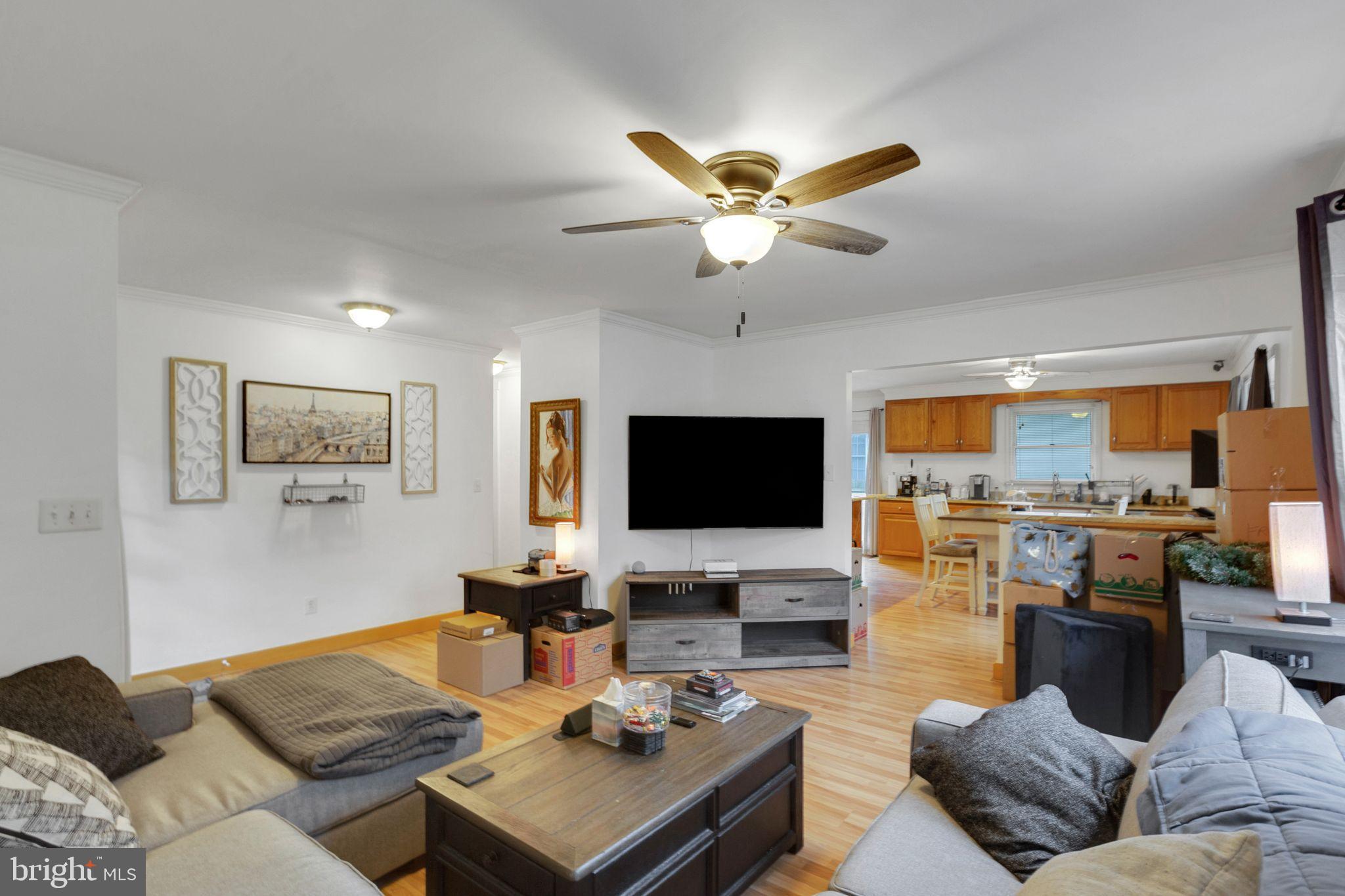 128 7th Street Colonial Beach, VA 22443 - Photo 6 of 32 a living room with furniture kitchen view and a flat screen tv