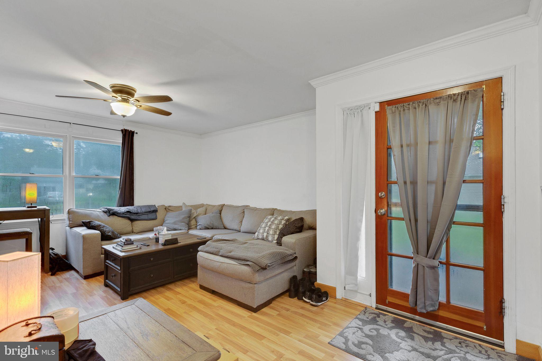 128 7th Street Colonial Beach, VA 22443 - Photo 7 of 32 a living room with furniture and a chandelier