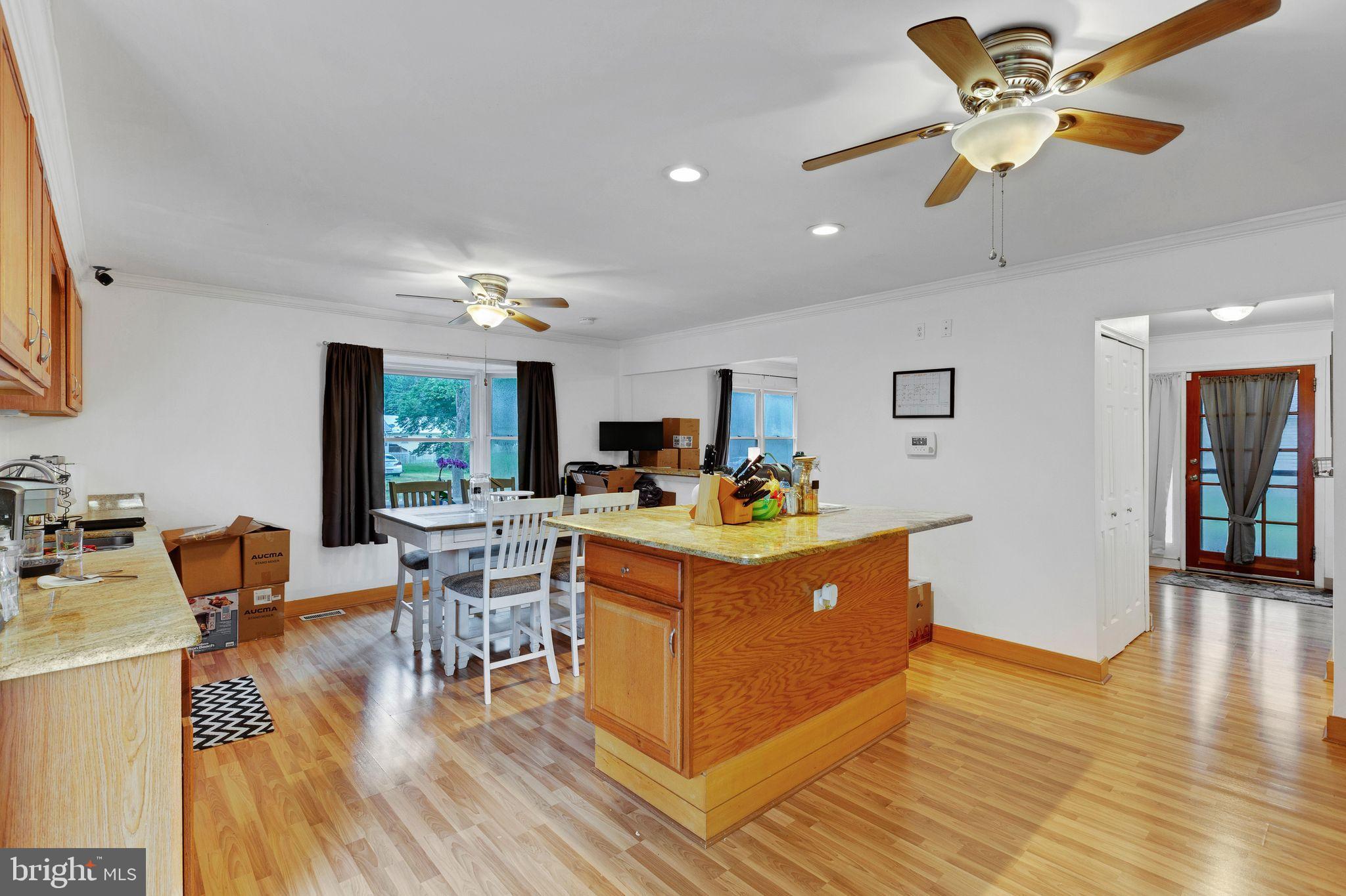 128 7th Street Colonial Beach, VA 22443 - Photo 10 of 32 a view of a dining room with furniture a chandelier and wooden floor