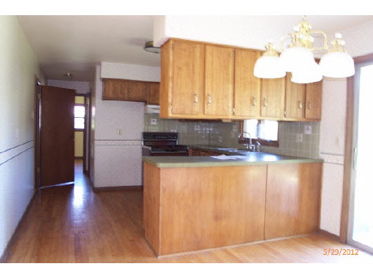 420 Rebecca Road Belvidere, IL 61008 - Photo 3 of 11 a kitchen with granite countertop wooden floors and stainless steel appliances