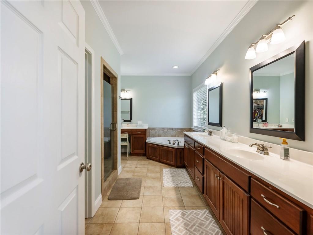 7657 Pea Ridge Road Lula, GA 30554 - Photo 20 of 76 a large bathroom with a double vanity sink and a mirror