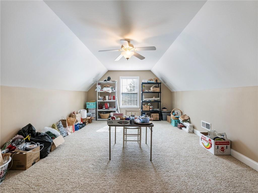 7657 Pea Ridge Road Lula, GA 30554 - Photo 29 of 76 a living room with furniture a chandelier fan and a window