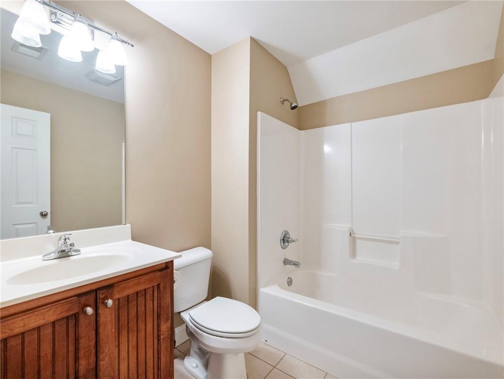 7657 Pea Ridge Road Lula, GA 30554 - Photo 31 of 76 a bathroom with a sink a toilet and shower