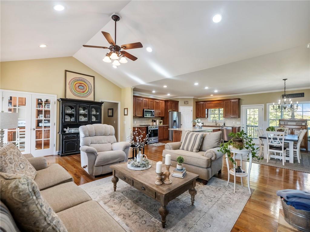 7657 Pea Ridge Road Lula, GA 30554 - Photo 5 of 76 a living room with furniture a rug and a chandelier