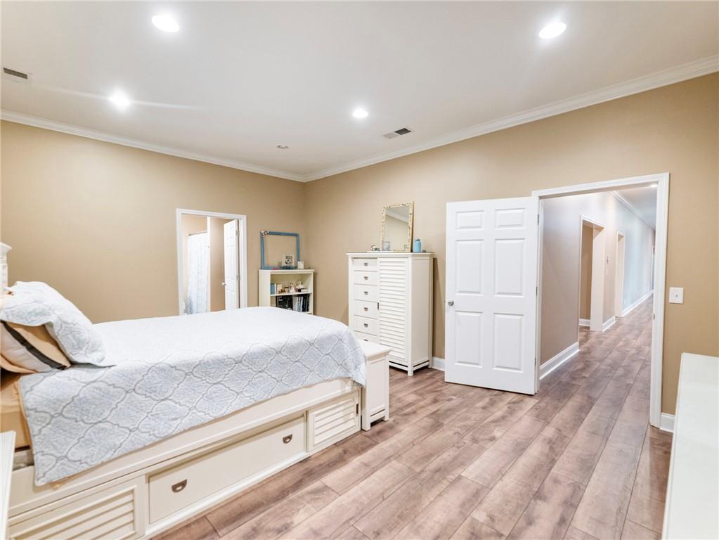 7657 Pea Ridge Road Lula, GA 30554 - Photo 52 of 76 a bedroom with a large bed closet and wooden floor