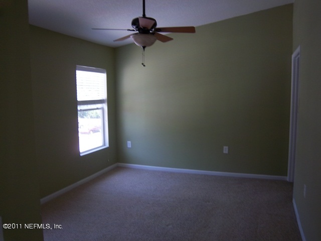 7920 Merrill Road, Unit 2113 Jacksonville, FL 32277 - Photo 4 of 7 an empty room with a window and a fan
