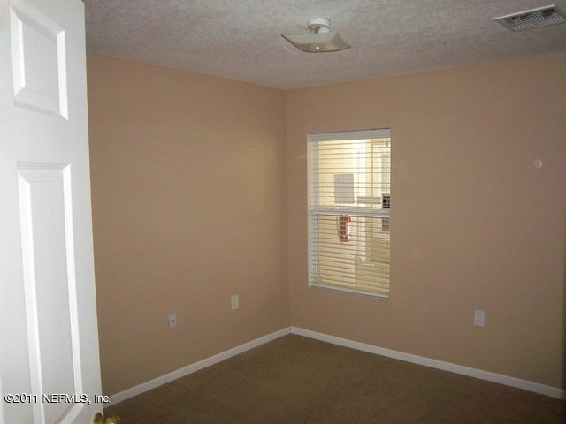 7920 Merrill Road, Unit 2113 Jacksonville, FL 32277 - Photo 6 of 7 an empty room with a window