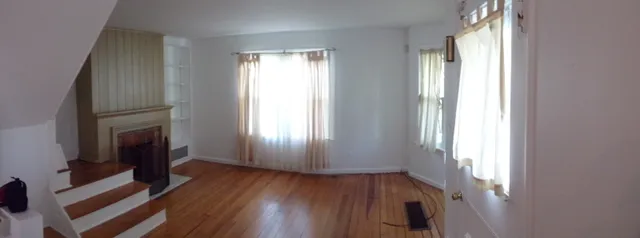 a view of livingroom with hardwood floor and a fireplace