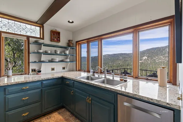 a kitchen with a sink and large window