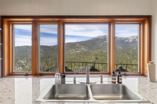 a kitchen with a sink and a large window